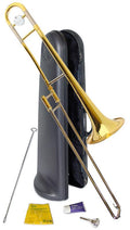 A Yamaha YSL-354E Student Tenor Trombone stands upright next to an open black hard case. In front are a cleaning rod, yellow polishing cloth, slide grease, and mouthpiece—all essentials for student players on a white background.